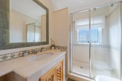 a bathroom with a sink and a shower at Villa Bougainvillea Palheiro Village by Holiday Rental Madeira in Funchal