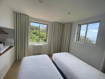 a bedroom with a bed with two towels on it at VM Sunset in Porto Moniz
