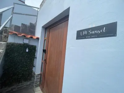 a bedroom with a bed with two towels on it at VM Sunset in Porto Moniz