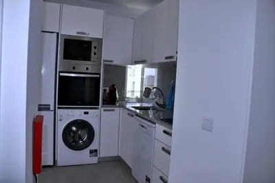 a kitchen with a washing machine and a washer at Apartamento DAVI in Funchal