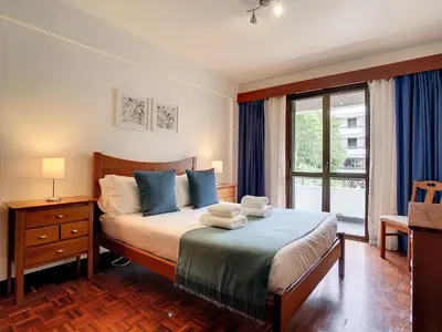 a bedroom with a bed with towels on it at Camoes Apartment by Atlantic Holiday in Funchal