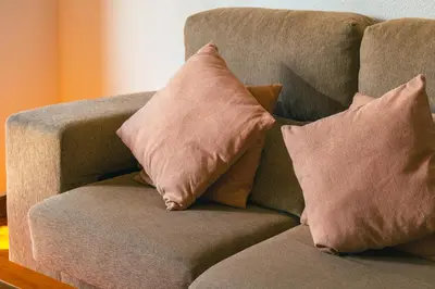 a couch with two pillows on top of it at Camoes Apartment by Atlantic Holiday in Funchal