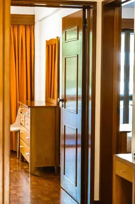 a room with a door and a dresser and a desk at Camoes Apartment by Atlantic Holiday in Funchal