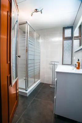 a bathroom with a shower and a sink and a counter at Camoes Apartment by Atlantic Holiday in Funchal