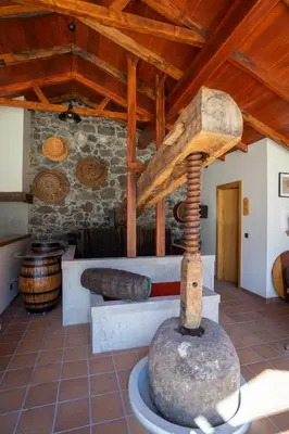a room with a stone stove in a building at Quinta Vale Vitis in São Vicente