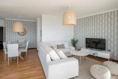 a living room with a white couch and a tv at Rodamar II by An Island Apart in Funchal