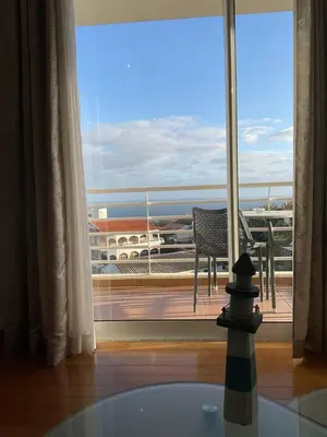 a view of a balcony with a table and a chair at Sol & Mar Rancho in Câmara de Lobos