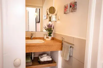 a bathroom with a sink and a mirror at Private Pool Apt. with Great View in Funchal