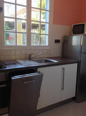 a kitchen with a sink and a refrigerator at Private Pool Apt. with Great View in Funchal