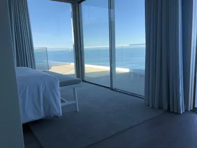 a bedroom with a bed and a view of the ocean at Casa Del Mar- Wonderfull Sea Views & Swimming Pool in Ponta Delgada