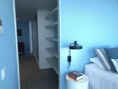 a bedroom with a bed and a lamp on a table at Casa Del Mar- Wonderfull Sea Views & Swimming Pool in Ponta Delgada