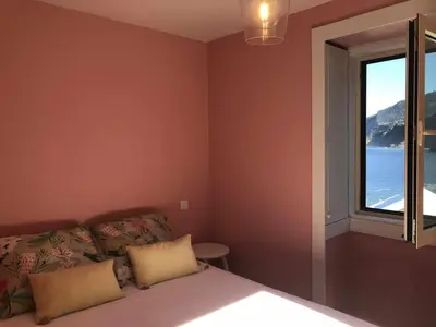 a bedroom with a bed and a window at Casa Del Mar- Wonderfull Sea Views & Swimming Pool in Ponta Delgada