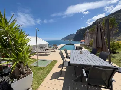 a patio with a table and a view of the ocean at Casa Del Mar- Wonderfull Sea Views & Swimming Pool in Ponta Delgada