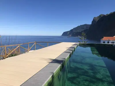 a swimming pool with a view of the ocean at Casa Del Mar- Wonderfull Sea Views & Swimming Pool in Ponta Delgada
