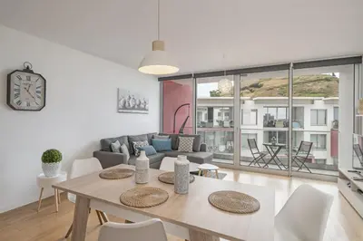 a living room with a table and a couch at Amparo Delight by Homie in Funchal