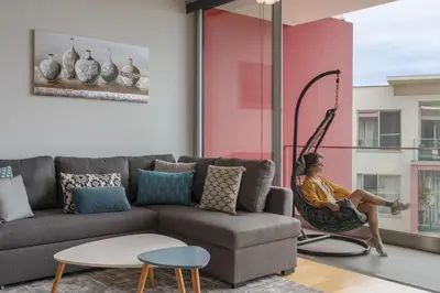 a woman sitting in a hammock in a living room at Amparo Delight by Homie in Funchal