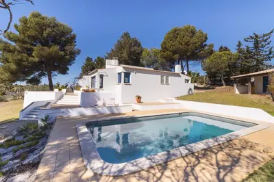 a villa with a swimming pool in front of a house at Casa do Barco in Luz