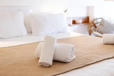 a pile of rolled towels on a bed at Casa do Barco in Luz