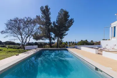 a swimming pool in the backyard of a house at Casa do Barco in Luz