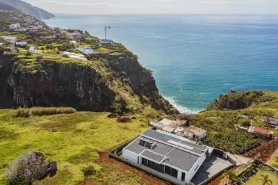 a house on a hill next to the ocean at OurMadeira - Ocean Panorama in Estreito da Calheta