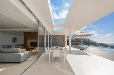 a living room with a couch and a table at OurMadeira - Ocean Panorama in Estreito da Calheta