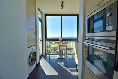a view of a kitchen with a view of a balcony at Rubeus in Caniço