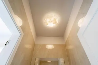 a bathroom with a round light on the ceiling at VILLA LEONARDO in Caniço