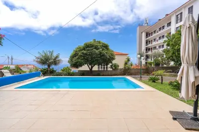a swimming pool in front of a building at VILLA LEONARDO in Caniço