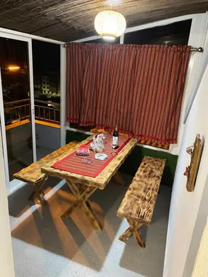 a table and bench in a room with a window at Lovely newly refurbished, 1 bedroom top floor apartment with sea views, fast WI-FI CABLE TV and Netflix in Ribeira Brava