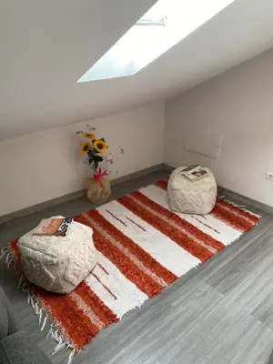 a room with two chairs and a rug on the floor at Lovely newly refurbished, 1 bedroom top floor apartment with sea views, fast WI-FI CABLE TV and Netflix in Ribeira Brava