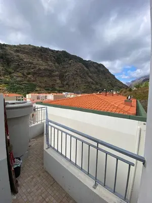 a balcony with a view of a mountain at Lovely newly refurbished, 1 bedroom top floor apartment with sea views, fast WI-FI CABLE TV and Netflix in Ribeira Brava