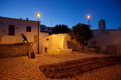 a man riding a skateboard down a wall at night at Casa Amado, Aldeia da Pedralva in Vila do Bispo
