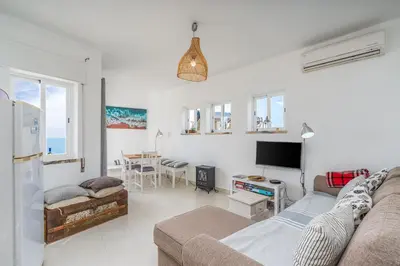 a living room with a couch and a tv at Vista Mar - Burgau in Burgau