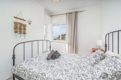 a bedroom with a bed with a stuffed animal on it at Vista Mar - Burgau in Burgau