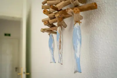 a group of wooden sticks hanging on a wall at Vista Mar - Burgau in Burgau
