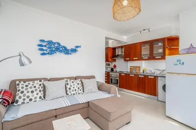 a living room with a couch and a kitchen at Vista Mar - Burgau in Burgau
