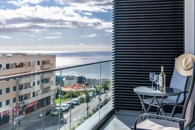 a balcony with a table and wine glasses at Fenix Ocean View by Homie in Funchal