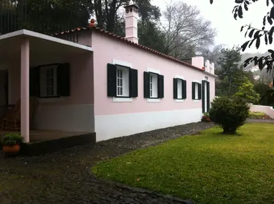 a house with a tower on top of it at Villa-sleeps2-garden-private park in Camacha