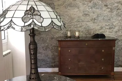 a lamp sitting on a table with a dresser at Villa-sleeps2-garden-private park in Camacha