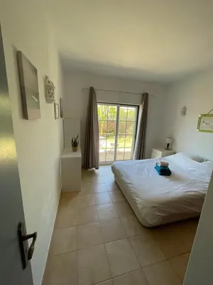 a bedroom with a bed and a large window at Spacious 3 bedroom villa with pool in Luz