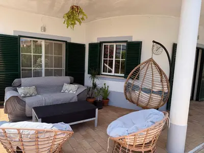 a living room with a couch and a swing at Spacious 3 bedroom villa with pool in Luz
