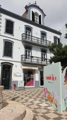 a white building with a sign in front of it at Edificio Charles 101 in Funchal