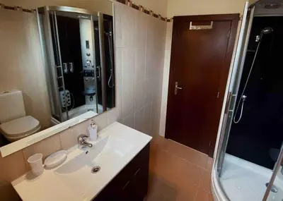 a bathroom with a sink and a shower at Brazão Guest House in Santana
