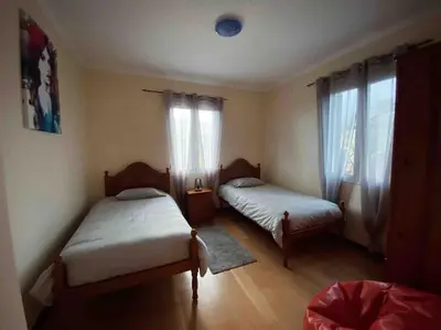 a bedroom with two beds and a window at Brazão Guest House in Santana