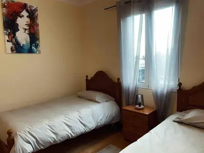 a bedroom with two beds and a window at Brazão Guest House in Santana