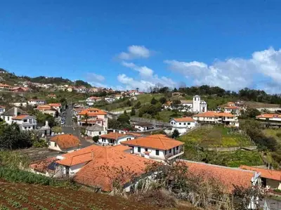 a view of a town with houses on a hill at Brazão Guest House in Santana