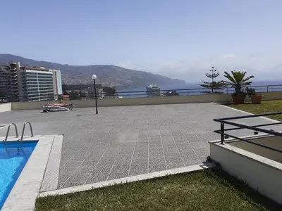 a swimming pool on the roof of a building at Madeira Inn Group in Funchal