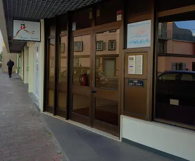 a store front with glass doors on a building at Madeira Inn Group in Funchal
