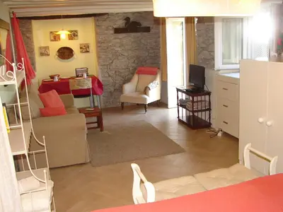 a living room with a kitchen and a dining room at Romantic Studio in Funchal