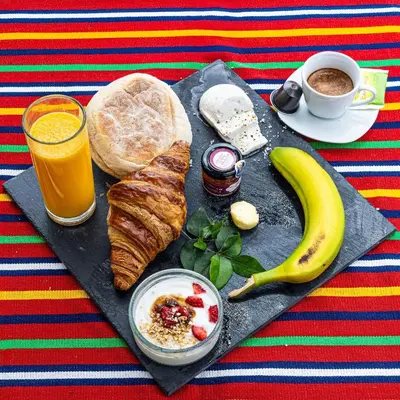 a breakfast of bread and a banana and a cup of coffee at Romantic Studio in Funchal